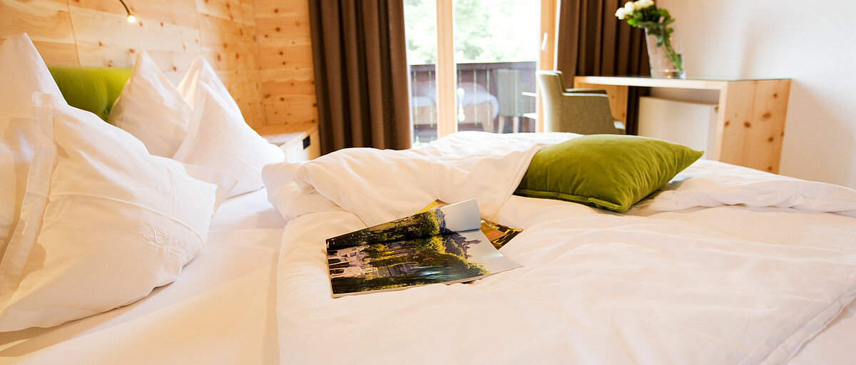 Bed in a Stone pine room in Minglers Sportalm in Kirchberg in the Kitzbühel Alps