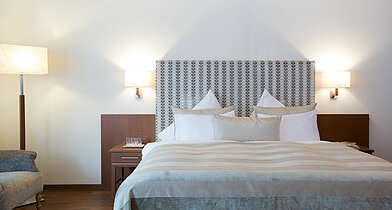 Bed in a deluxe double room in Minglers Sportalm near the Kitzbühel Alps