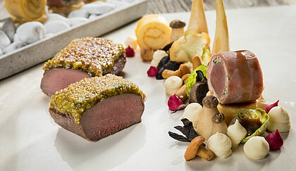 Meal with venison, potatoes and pistachios in the toque-awarded restaurant in your sports hotel in Kitzbühel